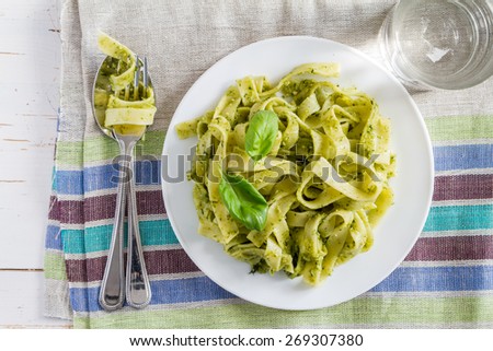 Similar – Image, Stock Photo Green tagliatelle pasta with ham, parmesan cheese, arugula and tomatoes on black plate