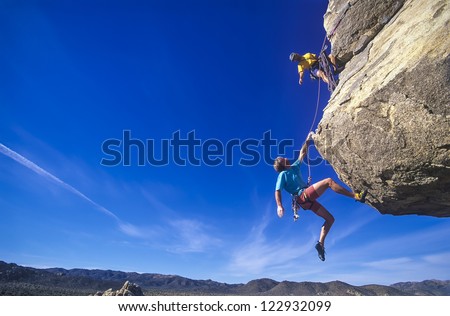 Rock climbing team struggle for success on a challenging ascent. 商業照片 © 