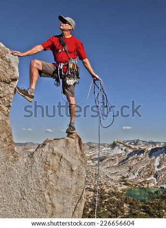 Climber on the edge of a challenging cliff.