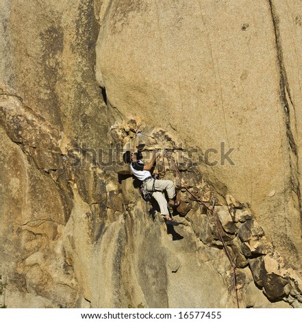 Rock climber scales a difficult route in the Split Rock area of Joshua Tree National Park.
