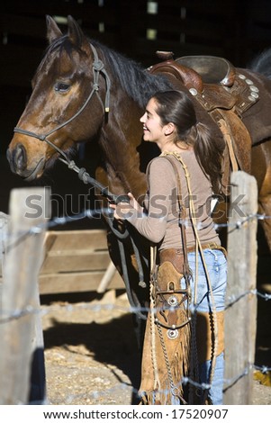 Young woman preparing for a horse ride in Santa Ynez, California, on a sunny afternoon.