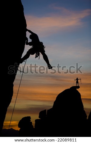 A climber clings to the side of an overhanging cliff in The Sierra Nevada Mountains, California.