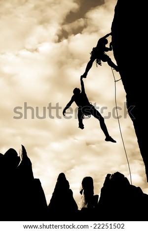 Team of climbers in trouble clinging to a cliff for dear life in The Sierra Nevada Mountains, California.