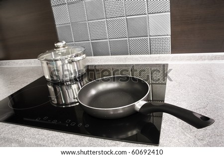 Modern kitchen. Steel pot and pan on the induction cooker