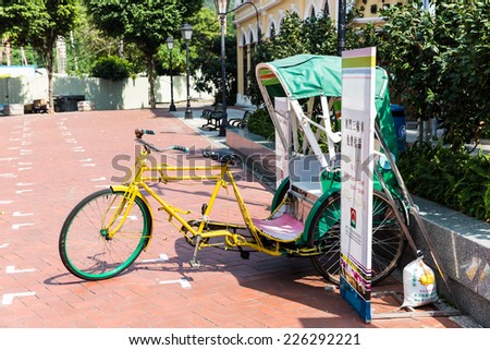 MACAU, CHINA - OCTOBER 16, 2014 - Tricycle display to promote tourisium by Macau Government Tourist Office