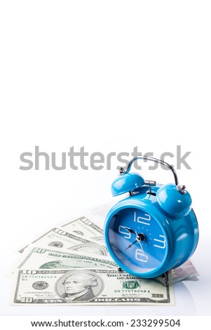 Blue old style alarm clock on top of pile of banknote (vertical shot and leave space for text)