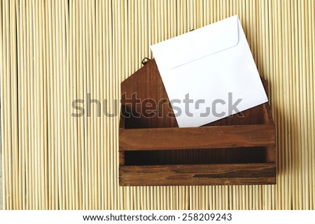 image of small letter box and white envelope on bamboo matt