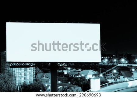 outdoor billboard with blur view of city in night time