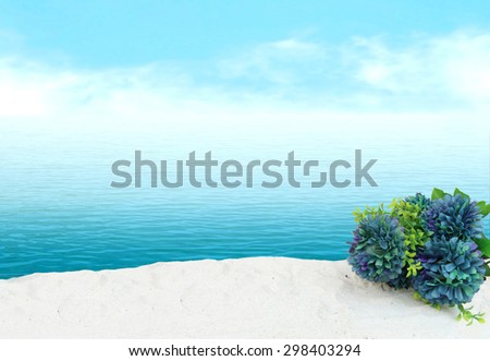 bunch of flower on sea sand with blur ocean background