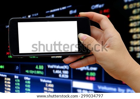 blur hand holding mobile phone on blur perspective stock market number background