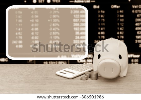white frame with piggy bank coins and calculator on blur stock market  number background ,vintage tone
