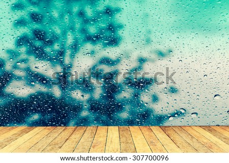 wet perspective floor with blur drop on mirror with dark tree background