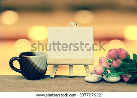 canvas frame ad coffee with blur bokeh light in restaurant background ,vintage tone