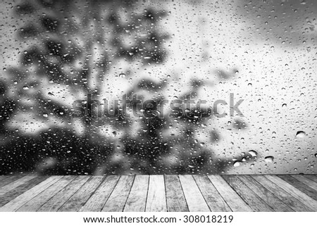 wet perspective floor with blur drop on mirror with dark tree background ,black and white tone