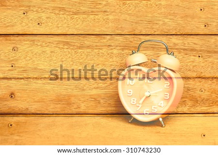 vintage clock with wooden wall and nails background ,vintage tone