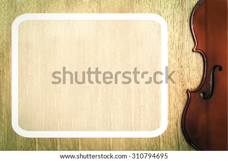 white frame and part from body of violin on wooden background