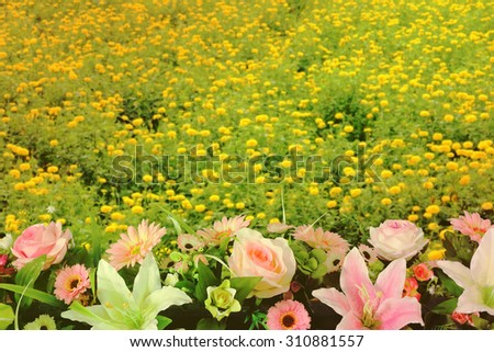 artificial florist with blur image of marigold garden background