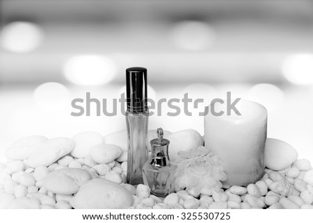 scented candles and cosmetic container on blur bokeh light in restaurant background ,,black and white tone