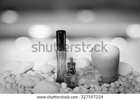 scented candles and cosmetic container on blur bokeh light in restaurant background  ,black and white tone