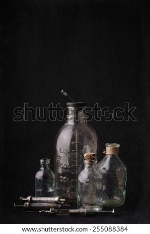 Pharmaceutical small bottles and squirts on the retro background