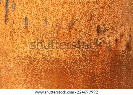 Rusty orange piece of metal, an ideal background texture.