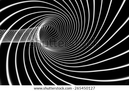 Abstract black and white tunnel of light, done via a long exposure suggests time travel into the unknown.