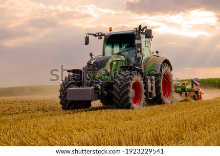 Similar – Image, Stock Photo Farmer on a tractor digs out potatoes from soil. Extract root vegetables to surface. Harvesting potatoes in autumn. Farming and farmland. Agricultural work in the field. Countryside.