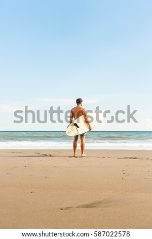 Similar – Image, Stock Photo Surfer at the beach carrying surfboard