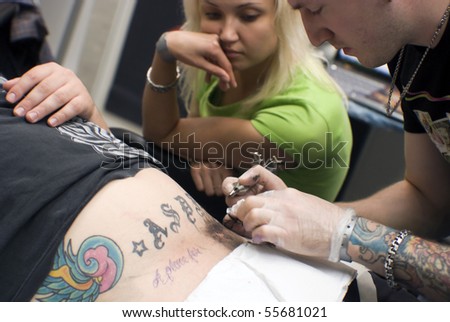 SAINT PETERSBURG - JUNE 20: Tattoo artist at work at St.Petersburg Tattoo Festival  - a four-day event on  art of tattooing, body modification, body art June 20, 2010 in St. Petersburg, Russia.