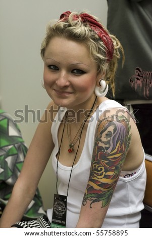 SAINT PETERSBURG - JUNE 20: A young  model at St.Petersburg Tattoo Festival  - a four-day event on  art of tattooing, body modification, body art June 20, 2010 in St. Petersburg, Russia.