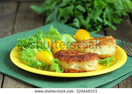 Cod fish cakes served with a salad.