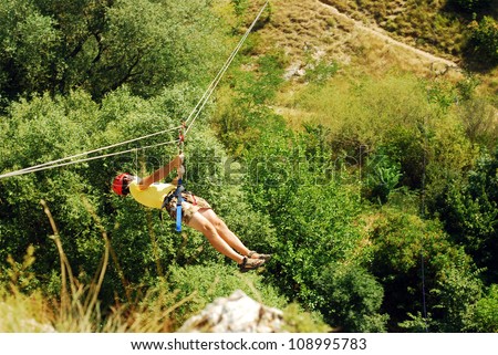 man descending on a zip-line (flying fox)