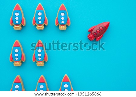 One red rocket fly turning in another path direction on blue background. Think differently, standing out from the crowd, creative thinking ideas in business and marketing concept. Photo stock © 