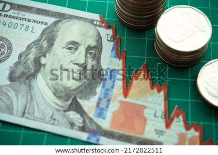 Tear off US dollar banknote and coins stacks as chart graph down. The Federal Reserve ( FED ) increase % interest rates to fix inflation crisis. World global economy recession and stagflation concept. Сток-фото © 