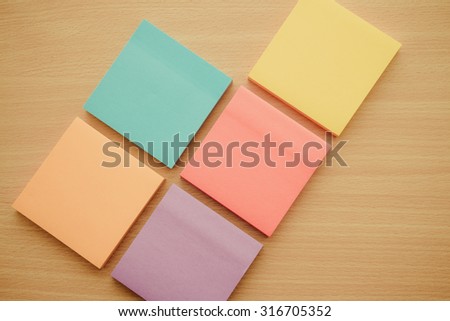 Color block of paper notes on wood table - Retro filter effect