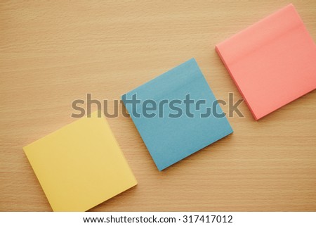 Color block of paper notes on wood table - Retro filter effect