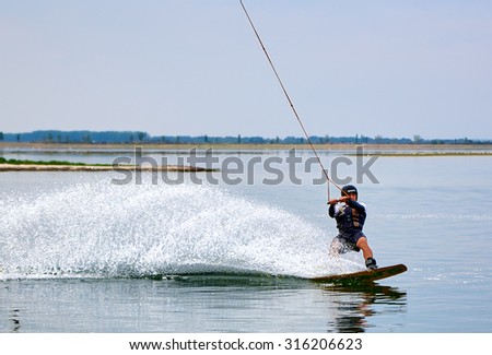 Lazurne, Ukraine - August 23, 2015: Wakeboarder shows extreme trick at the youth festival \