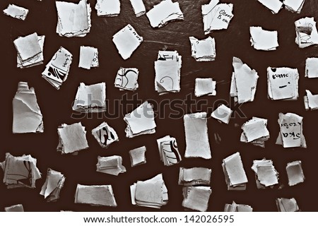 black background with white scraps of paper closeup