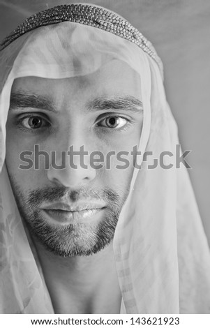 Portrait of a young man in the Arabian headscarf closeup