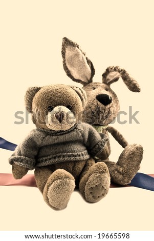 Two plush toys on a beige background