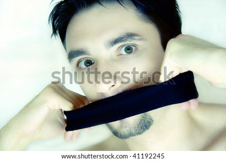 scared young man with a bandage on a mouth