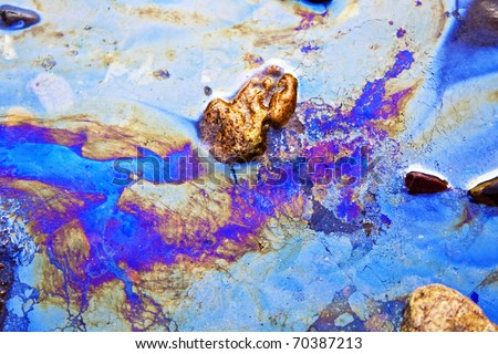 water with different colored patches of gasoline and oil