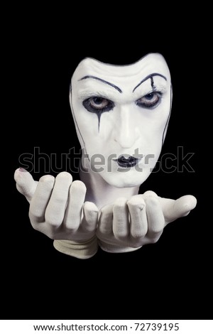 face and hands of mime with dark make-up isolated on black background