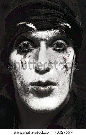 theatrical actor with dark makeup on her face