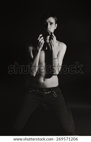 young slender naked man on a black background