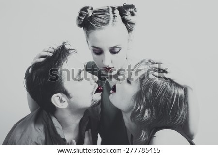 Two women and one man with the red ripe cherries close up