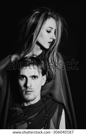 young man and woman on black background