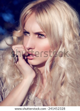 Fashion Beauty Blonde Model Girl with Beautiful spring girl in blooming tree  Flowers .Green eyes. Bride. Perfect Creative Gloss Make up and Hair Style. Hairstyle.