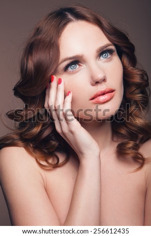 Young woman with beautiful healthy face and hair. Hand on the face