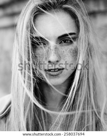 black and white portrait of a beautiful girl with freckles
